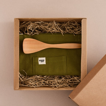 Gift box with apron and cooking spoon 
