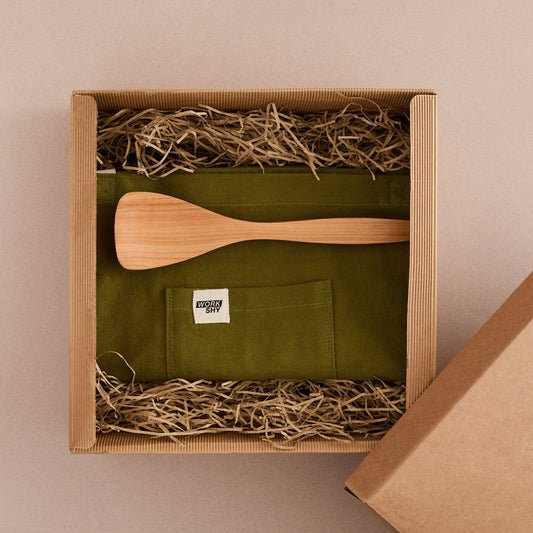 Gift box with apron and cooking spoon 