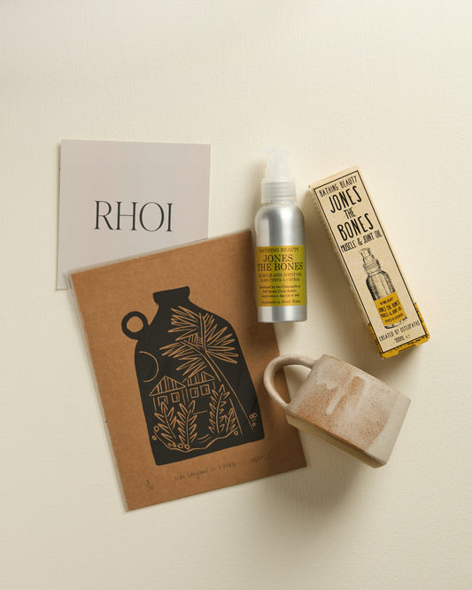 Product display with a bottle, mug, and branded items on a neutral background