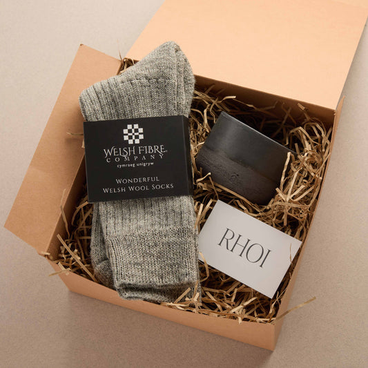 Box containing a pair of grey socks,a handthrown mug